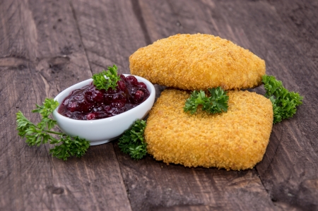 Portion of fried Gouda on wooden backgroundの写真素材