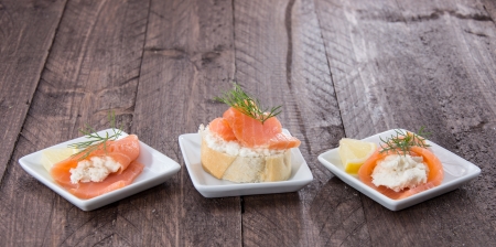 Salmon appetizers on wooden background