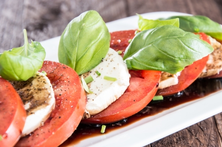 Plate with Tomato and Mozzarella topped with Balsamic Vinegarの写真素材