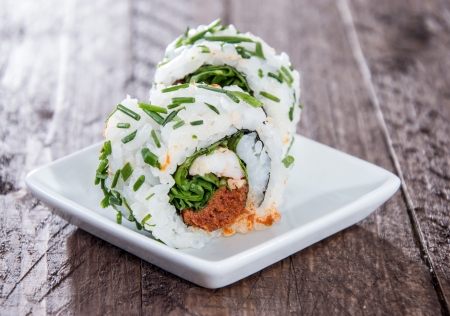 Small plate with Sushi Rolls on wooden backgroundの写真素材