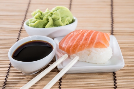 Nigiri Sushi with Soy Sauce and Wasabi on a small plateの写真素材