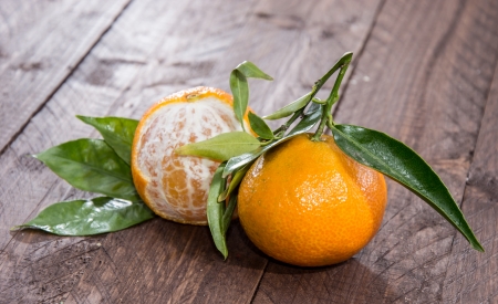 Fresh Tangerine with leaves on wooden backgroundの写真素材