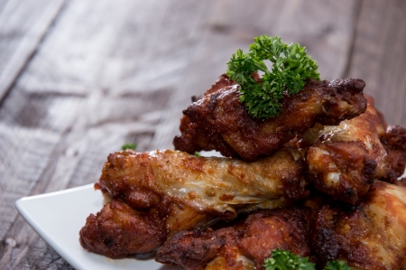 Chicken Wings on a plate on wooden backgroundの写真素材