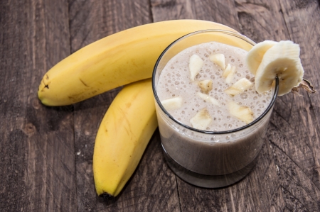 Banana Smoothie with fresh fruits on wooden backgroundの写真素材