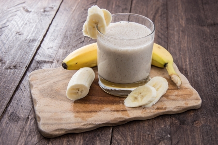 Fresh made Banana Milkshake on wooden backgroundの写真素材