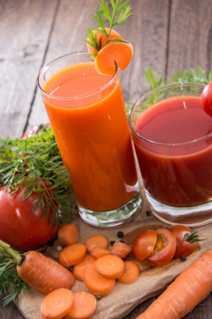 Carrot- and Tomato Juice with fresh pieces of ingredientsの写真素材