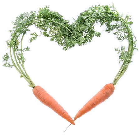 Fresh Carrots shaping a Heart isolated on white