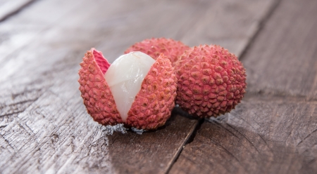 Fresh Lychees (macro shot) on wooden backgroundの写真素材