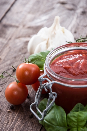 Tomato Sauce woth fresh ingredients on wooden backgroundの写真素材