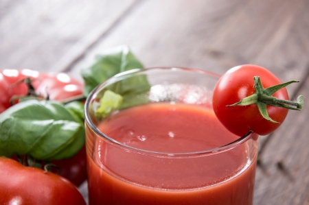 Tomato Juice with fresh Tomatoes on wooden backgroundの写真素材