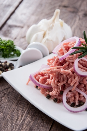 Plate with portion of Minced Meat on wooden backgroundの写真素材