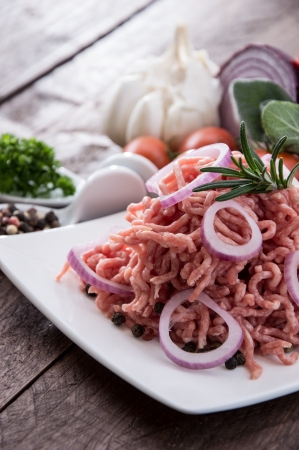 Plate with portion of Minced Meat on wooden backgroundの写真素材