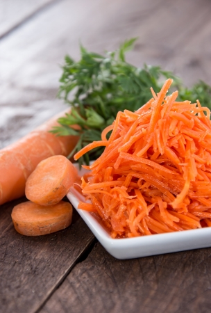 Small Plate with Carrot Salad on wooden backgroundの写真素材
