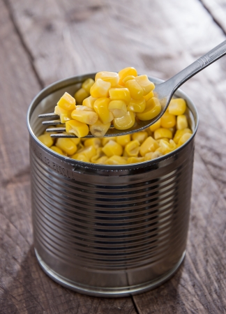 Canned Corn with Fork on wooden backgroundの写真素材