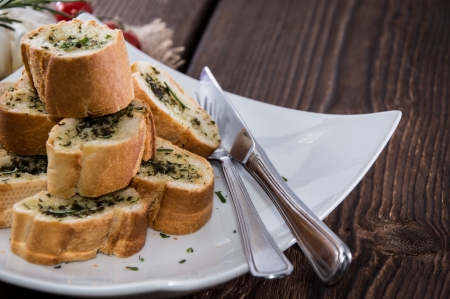 Some Garlic Bread pieces on wooden backgroundの写真素材