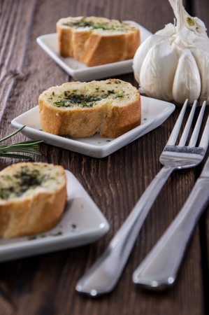 Portion of Garlic Bread on wooden backgroundの写真素材