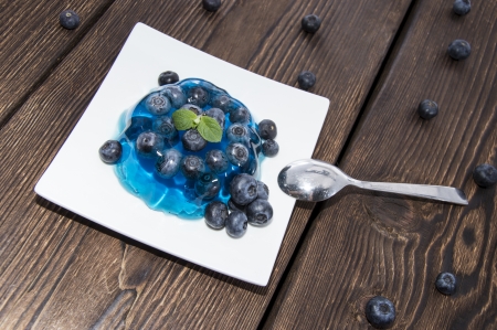 Portion of Blueberry Jelly with fresh fruits on wooden backgroundの写真素材