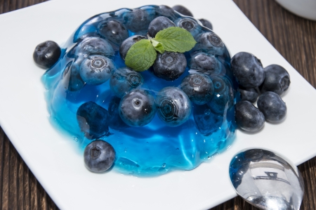 Portion of Blueberry Jelly with fresh fruits on wooden backgroundの写真素材