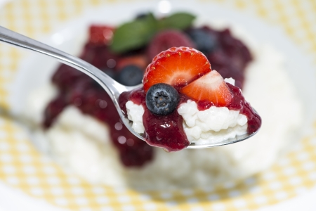 Rice Pudding with fruits on a spoon (blurred portion in the background)の写真素材
