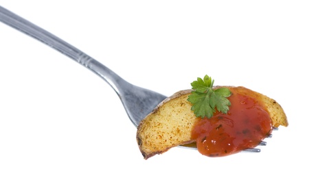 Potato Wedges on a fork isolated on white backgroundの写真素材