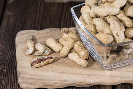 Heap of Peanuts on rustic wooden background