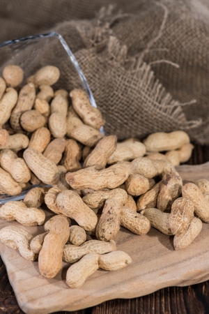 Heap of Peanuts on rustic wooden background