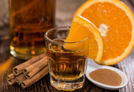 Tequila Gold with Cinnamon on wooden background
