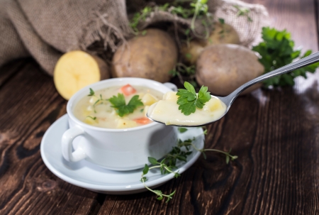 Fresh made Potatoe Soup in a bowl with herbsの写真素材