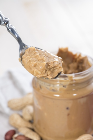 Fresh made creamy Peanut Butter in a glassの写真素材