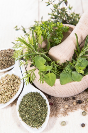 Fresh herbs in a small wooden bowl (macro shot)の写真素材