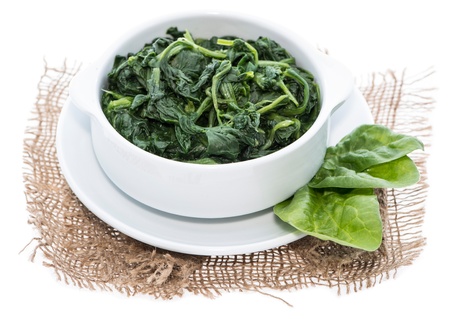 Portion of fresh cooked Spinach isolated on white backgroundの写真素材