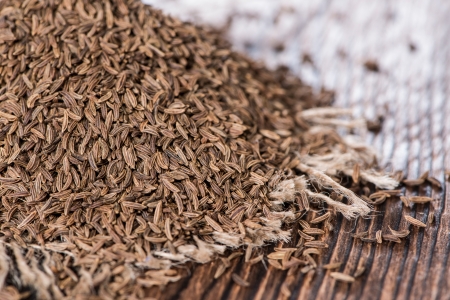 Heap of Caraway on vintage wooden background (macro shot)の写真素材