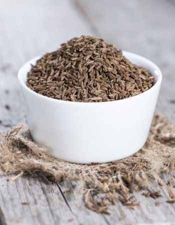 Bowl with Caraway on vintage wooden background (macro shot)の写真素材