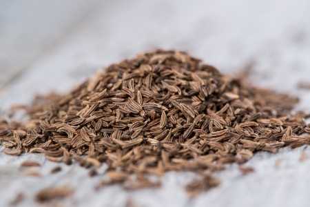 Heap of Caraway on vintage wooden background (macro shot)の写真素材