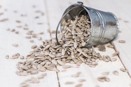 Fresh Sunflower Seeds on wooden backgroundの写真素材