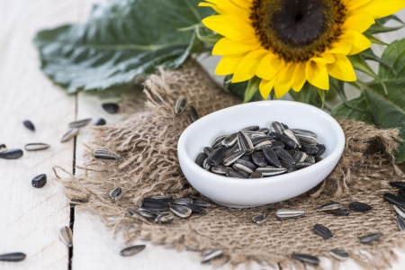 Fresh Sunflower Seeds on wooden backgroundの写真素材