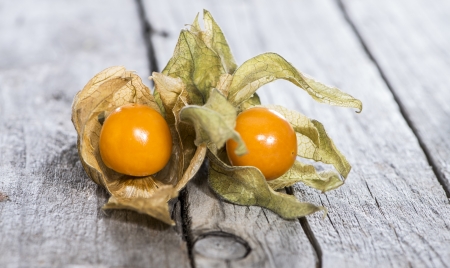 Fresh Physalis Fruits on vintage wooden background