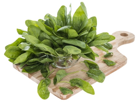 Portion of fresh Spinach Leaves isolated on white background