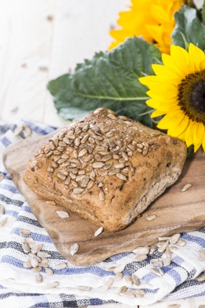 Homemade Bun with Sunflower Seeds on wooden backgroundの写真素材