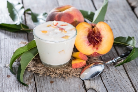Portion of Peach Yogurt on wooden backgroundの写真素材