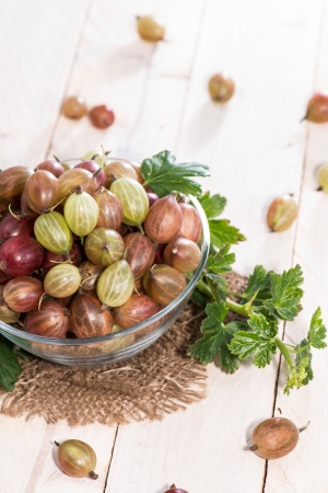Portion of Gooseberries on bright wooden backgroundの写真素材