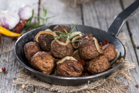 Portion of homemade Matballs with fresh herbs in a panの写真素材