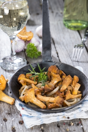 Fried Chanterelles with onions and fresh herbsの写真素材