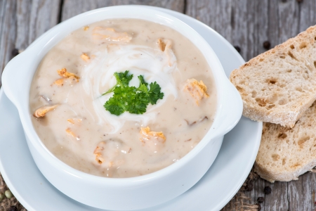 Bowl with Chanterelle Cream Soup and fresh herbsの写真素材