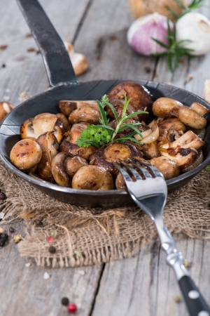 Mushrooms in a vintage Pan with fresh herbsの写真素材