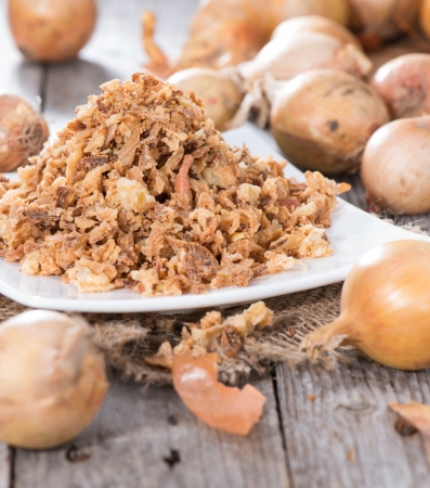 Portion of fresh Fried Onions on wooden backgroundの写真素材