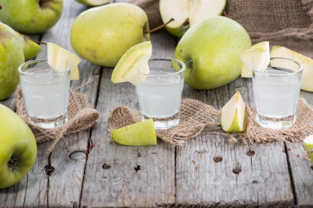 Apple Liqueur Shots on wooden の写真素材