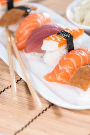 Portion of Sushi with chopsticksの写真素材