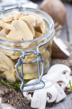Portion of Canned Mushrooms on wooden backgroundの写真素材