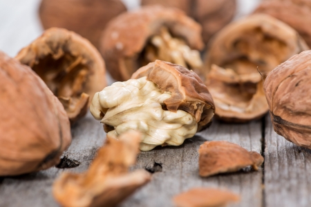 Walnuts on wooden background (macro shot)